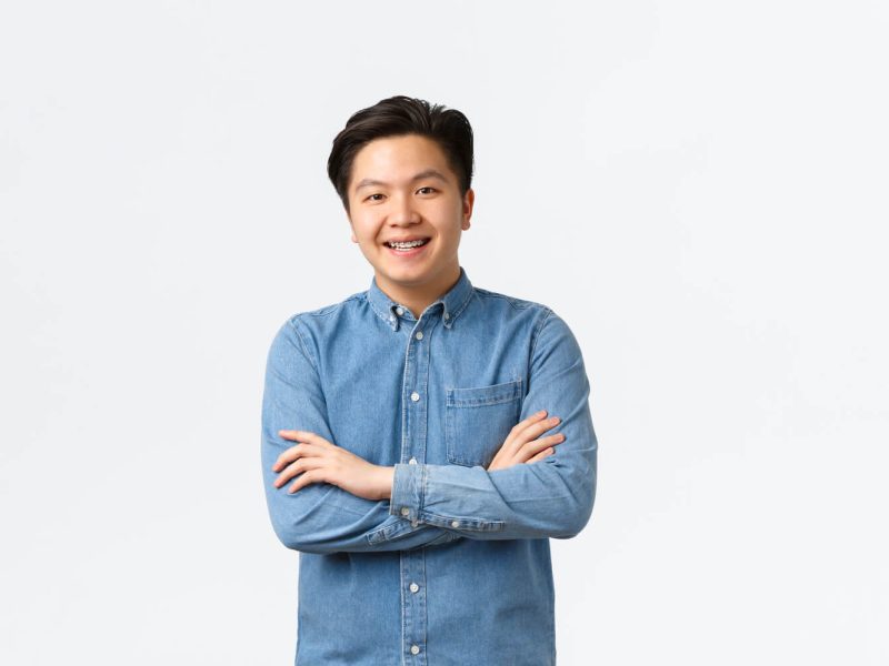 smiling-asian-guy-looking-happy-at-camera-cross-a-2022-12-16-05-49-31-utc (1) (1)